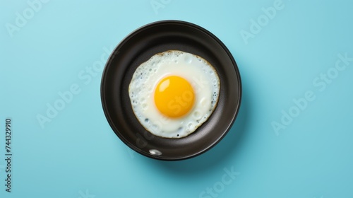 Egg yolk in blue frying pan