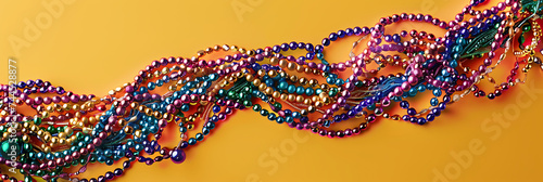 colorful mardi gras beads on a yellow background in t