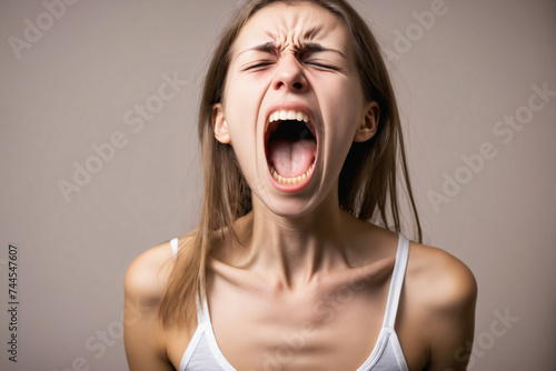 Young woman suffering from anorexia nervosa screaming in pain