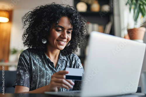 girl using her credit card to buy with her laptop