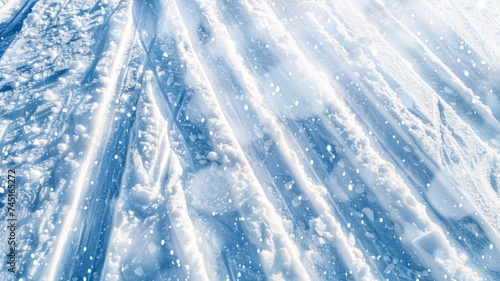 Close-up of ski tracks on a snowy slope with sunlight casting shadows, suitable for winter sports themes.