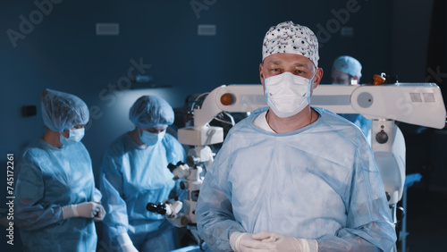 The concept of advertising ophthalmological services, vision correction and treatment. Surgeon in the ophthalmology operating room after the completion of the operation.