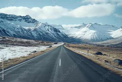 A serene image of an empty road with majestic mountains in the background. Perfect for travel or nature-themed designs