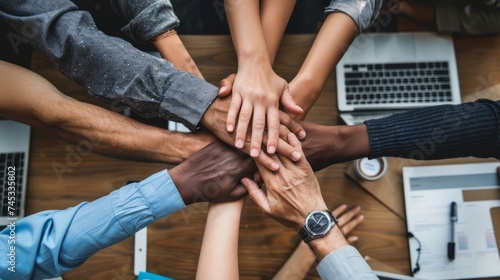 Diverse team building: multicultural members join hands in unity, emphasizing workplace collaboration and inclusivity