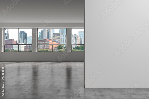 Downtown Nashville City Skyline Buildings from High Rise Window. Beautiful Expensive Real Estate overlooking. Empty room Interior. Mockup wall. Skyscrapers Cityscape. Day. Tennessee. 3d rendering.