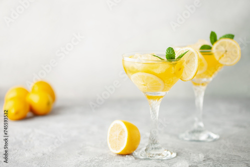 Summer limoncello margarita cocktail with lemons and mint in a glass