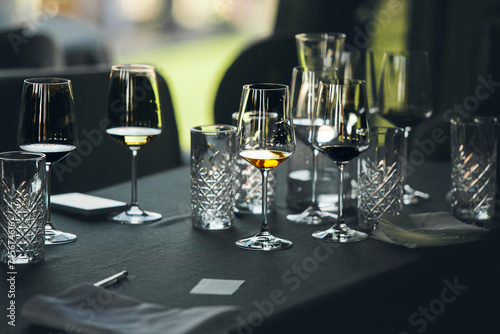 Layout of wine glasses on the table, preparing for the tasting of alcoholic beverages. Preparation to blind wine degustation for beginners sommelier. Wine school, winemaking lecture.