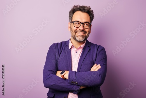 Portrait of a handsome middle-aged man in a purple jacket and glasses.