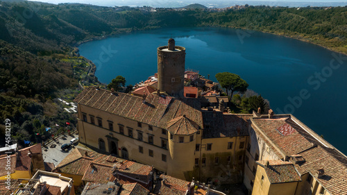 Aerial view of Nemi, a town of Castelli Romani regional park, in the Metropolitan City of Rome, Italy. The historic center is located in the Alban Hills overlooking Lake Nemi, a volcanic crater lake. 