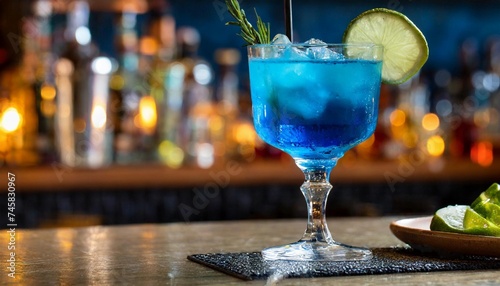 Glass of blue drink in bar on wooden table. Alcoholic drink.