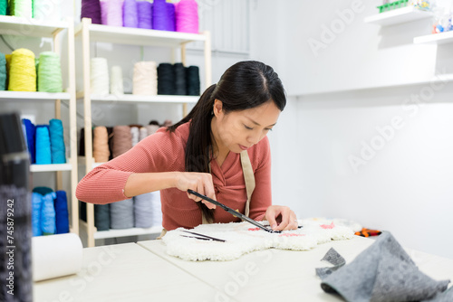 Woman choose the color of thread for making of tufting carpet at studio