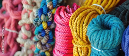 This close-up photo showcases a variety of colorful ropes, including ribbons, laces, and wool balls, highlighting their intricate design and ornamentation.