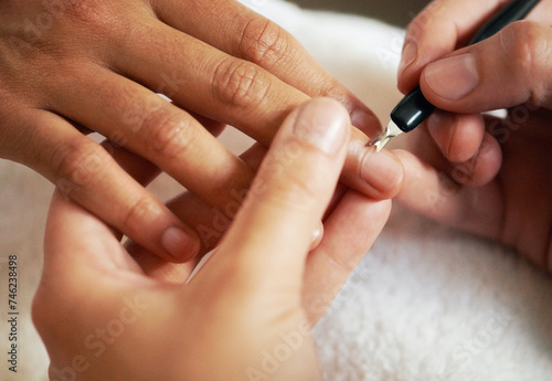 Hands, manicure and cuticle for nails in salon, beauty and treatment to relax. Closeup, spa and tool on fingernail, cleaning and cosmetic service with professional, pamper and luxury for wellness