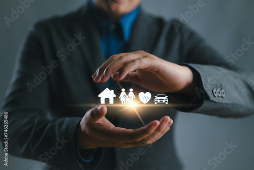 Businessman with protective gesture and car, family, life and health insurance icons. Insurance concept.