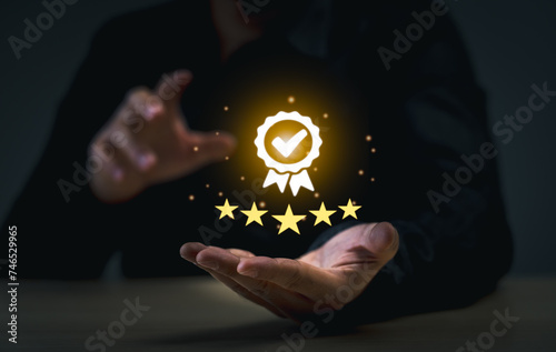 Business Quality Achievement and Excellence Concept. Businessman showcases a glowing five-star rating and award badge, symbolizing high quality and excellence in business.