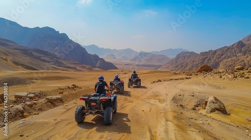  In the stone desert of the Sinai Peninsula, tourists embark on an adventure-filled excursion, exploring the rugged terrain on quad bikes. The wide panorama showcases the expansive mountain landscape