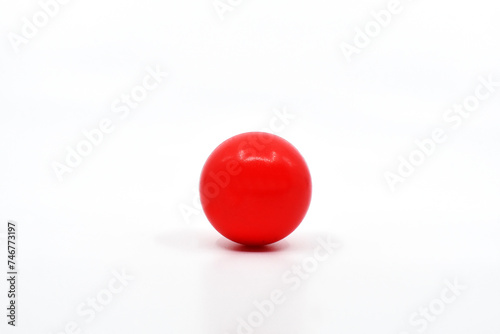 Single red ball isolated on a plain white background. Copy space. No people.