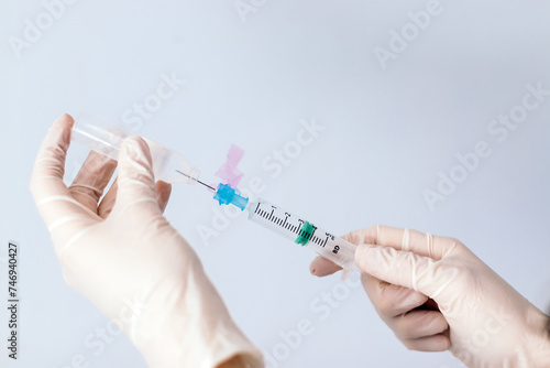 hands with syringe injecting serum