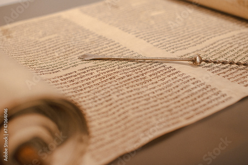 Jewish rabbi read the Torah scroll with his Torah reading hand.