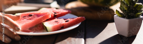 plate watermelon slices foreground female