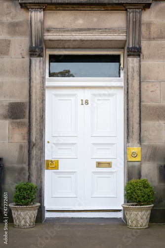 Old Georgian stone townhouse door with fanlight window above door