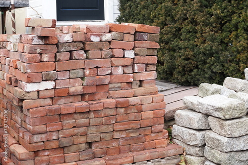 The piles of bricks and stones will be used in a construction project.