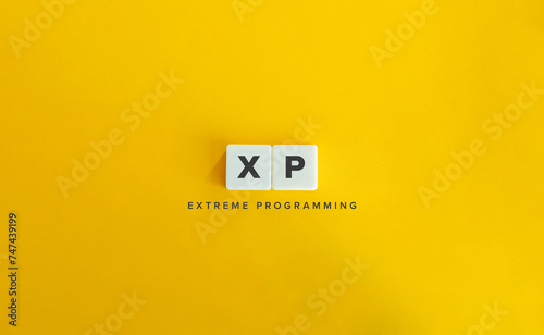 Extreme Programming (XP) Acronym and Term. Software Development Methodology. Text on Block Letter Tiles on Yellow Background.
