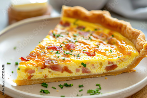 A plate of quiche Lorraine, a savory tart made with eggs, cream, bacon, and cheese