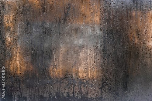 a wet fogged window with water droplets