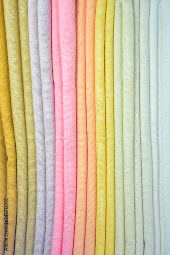 stack of colourful cotton clothes, close up pile of clothing
