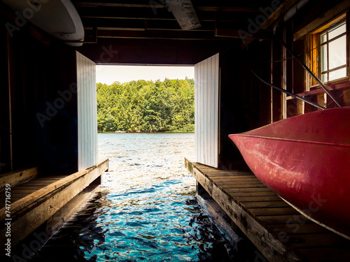 View out to the lake from inside a cottage boathouse in Canada.