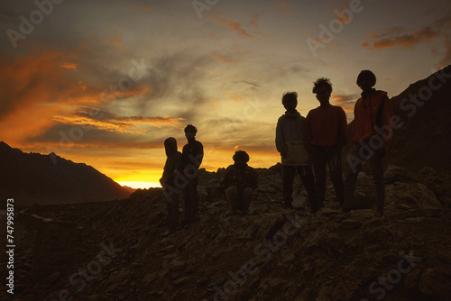 Dark silhouettes of indian men during sunset in Ladakh