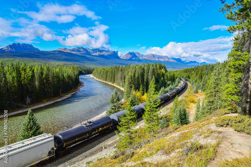 Long freight train moving along Bow river in Canadian Rockies ,Banff National Park, Canadian Rockies,Canada.