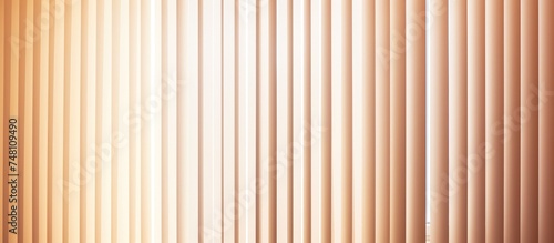 A room featuring a large window covered in closed vertical blinds, with sunlight peeking through the slats. The blinds create an abstract pattern on the floor,