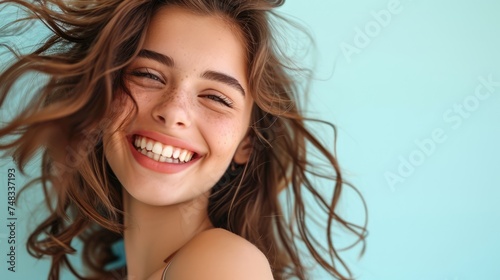 The girl's captivating smile reveals her immaculate, shining teeth, exuding charm and cheerfulness.