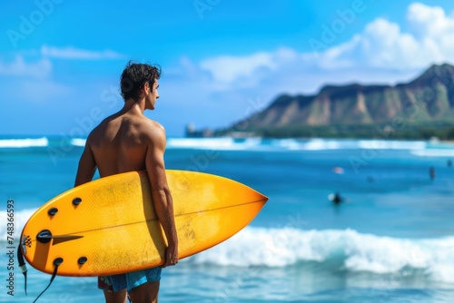 Young man embraces Hawaii surfing lifestyle in Honolulu Oahu.