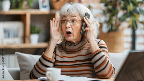Surprised shocked mature woman talking on mobile phone