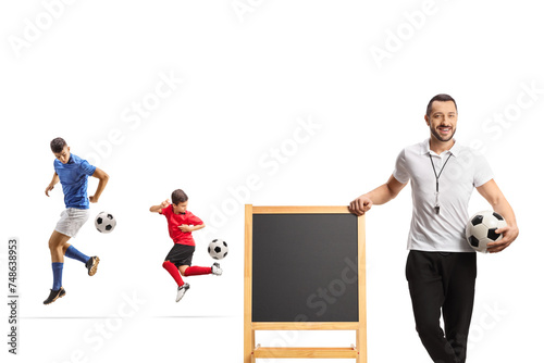 Football players at training and coach leaning on a blackboard