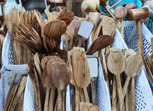 Wooden brown kitchen spoons for mixing food, on the shop window