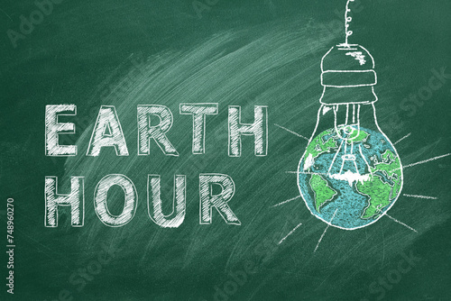 Light bulbs with lettering EARTH HOUR hand drawn in chalk on a school greenboard. Save the World. Save our planet.