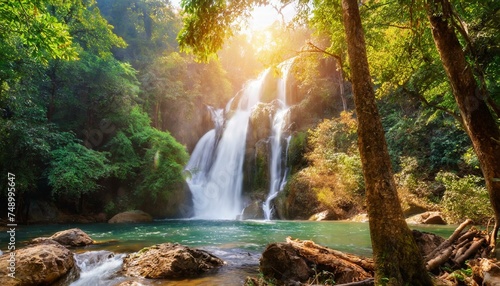 A beautiful waterfall in forest, river flowing, the sun shining