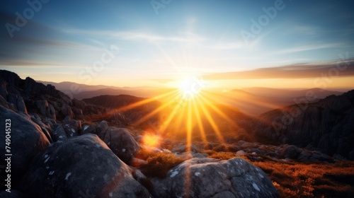 a sun shining through the clouds over a rocky mountain