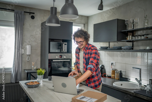 one man checking box of received package or product at home