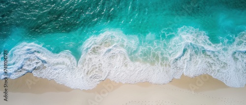 Aerial top view of ocean sea waves on pristine white sand beach with beautiful crystal clear turquoise water banner background