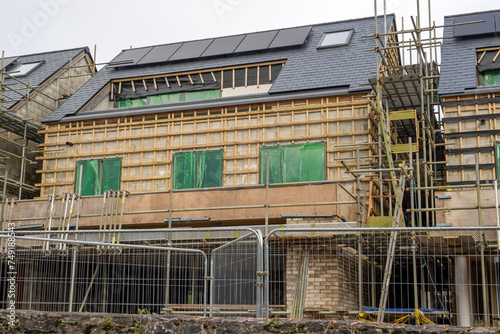 A residential development site lies closed with half-built uncompleted houses due to the contractor going into receivership