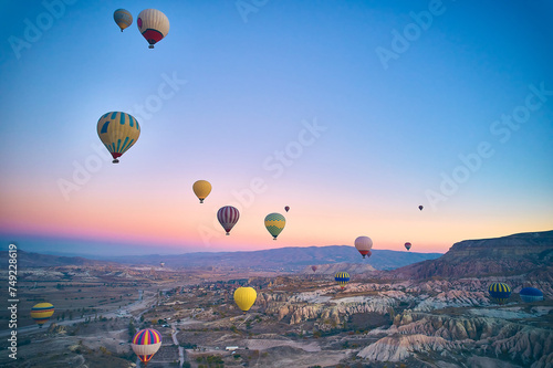 Drone point of view of hot air balloons above spectacular volcanic landscape of Cappadocia. Goreme national park. UNESCO World Heritage site. Nevsehir province, Turkiye