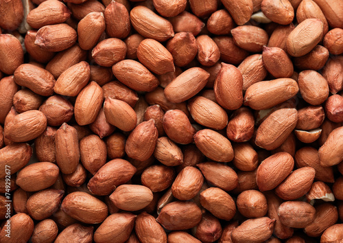 Raw peeled red peanut nuts top view macro background.Top view.