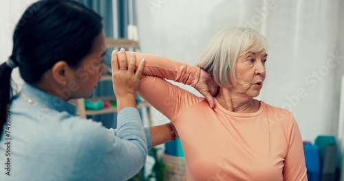 Physiotherapy, stretching and senior woman in consultation for support, exam and helping with shoulder or muscle. Doctor, physiotherapist or nurse and elderly patient arm or elbow, check and service