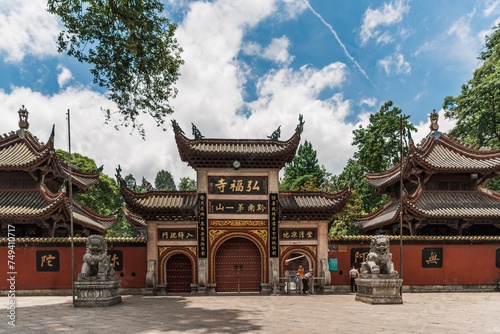 Gate of a traditional mansion in China with 2 stone lions on both sides