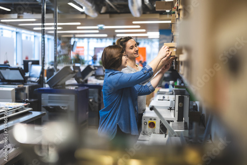 Professional female employees working in a printing house